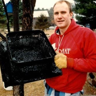 Dan, an installer back then now our Vice President, holding a creosote filled rain cap at a customer's home.