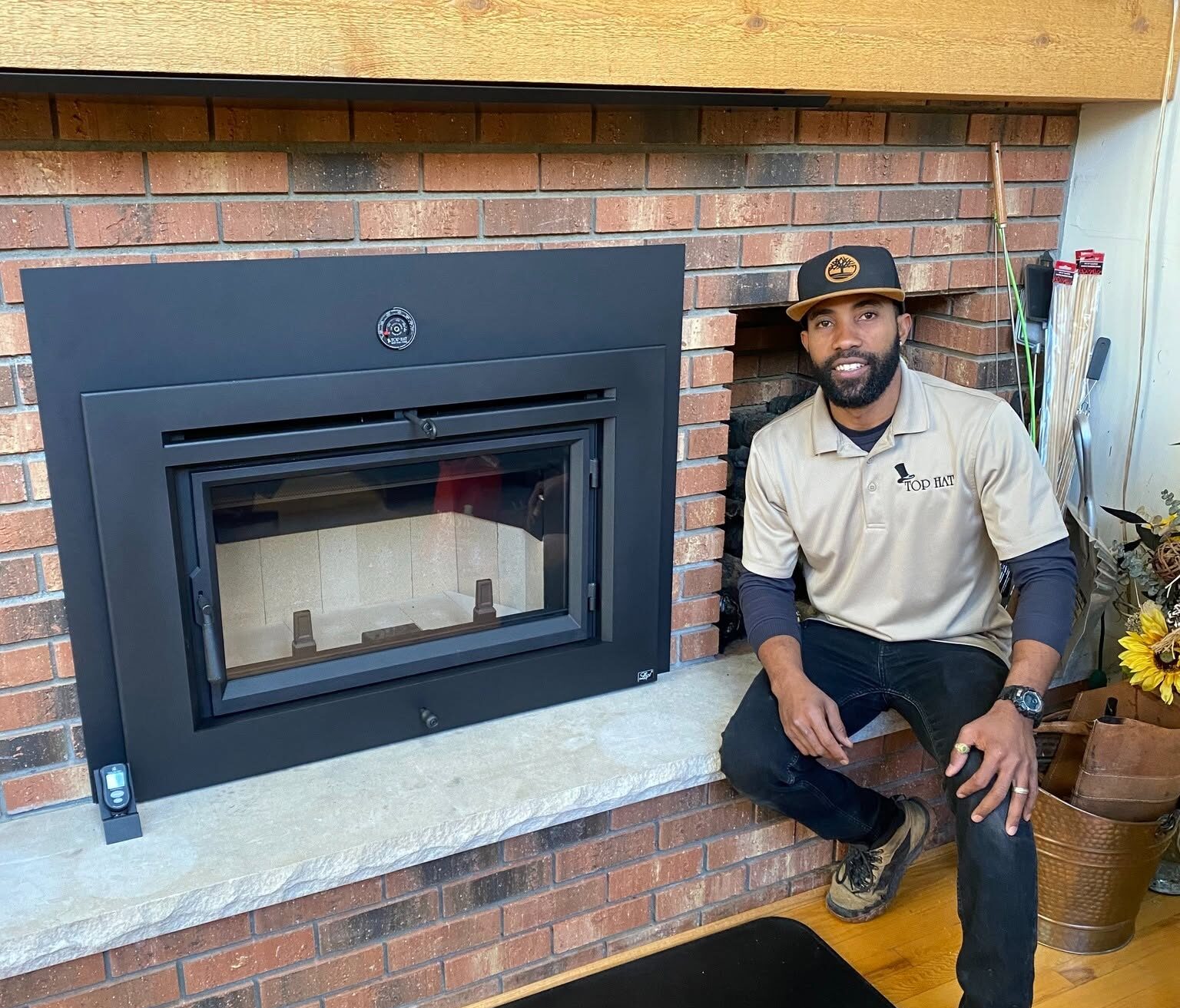 Installation crew sitting next to finished fireplace