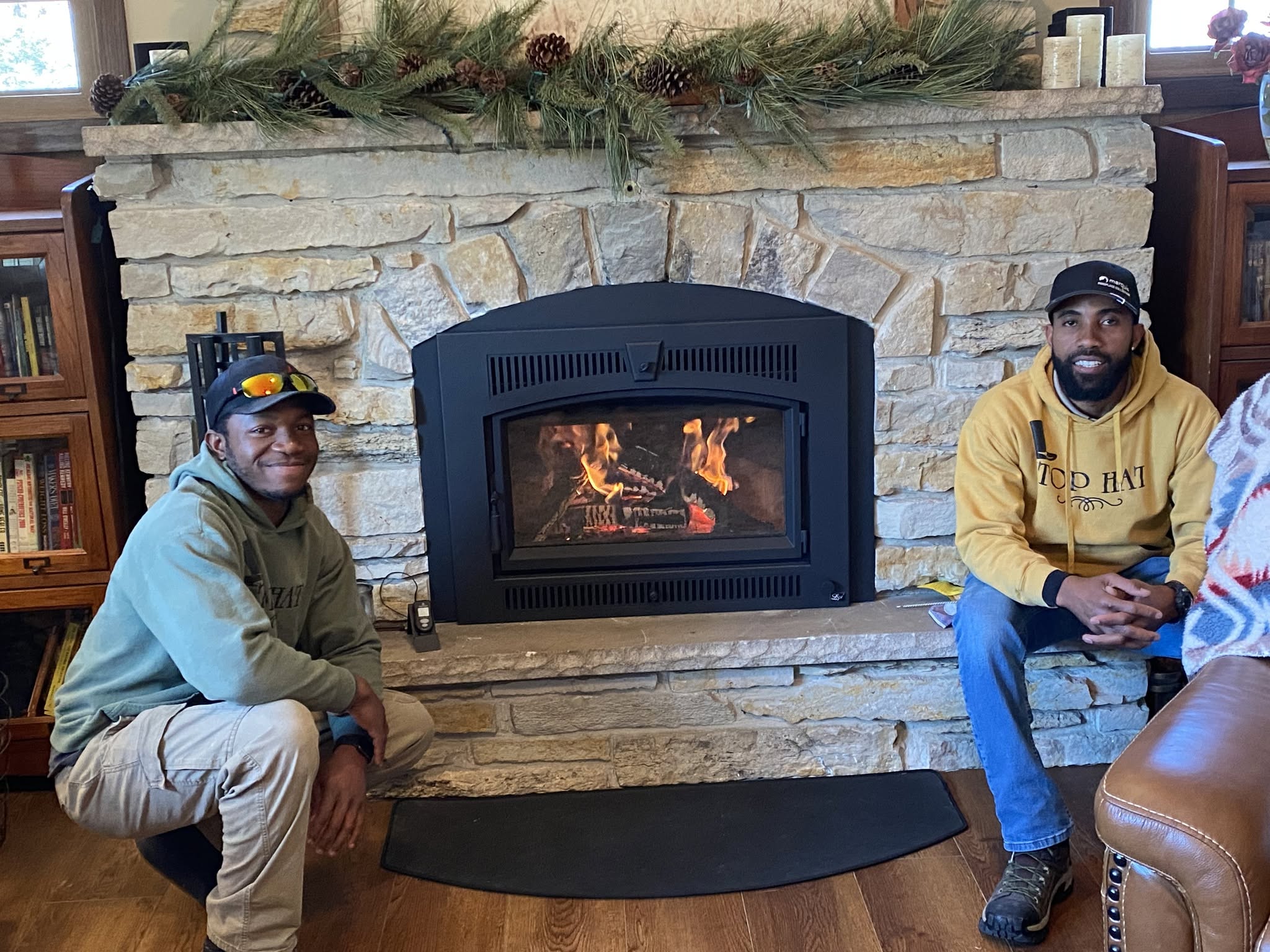 Top Hat installation team with a completed custom fireplace installation in a living room.